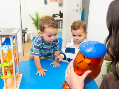 Young child playing and talking, illustrating speech milestones for three-year-olds
